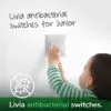 a toddler switching on schneider electric's livia series anti bacterial switches
