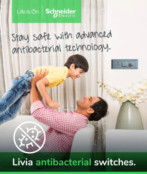 a father lifting his son in a living room where schneider electric's livia switches are displayed